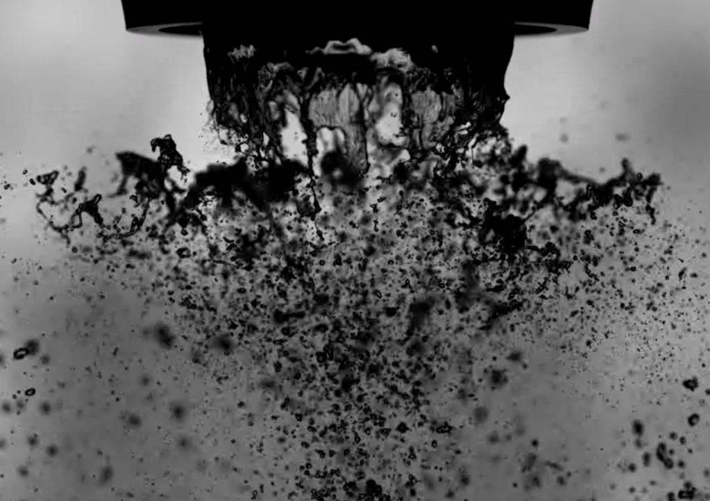 A liquid sheet breaking up into droplets in a turbulent shear flow